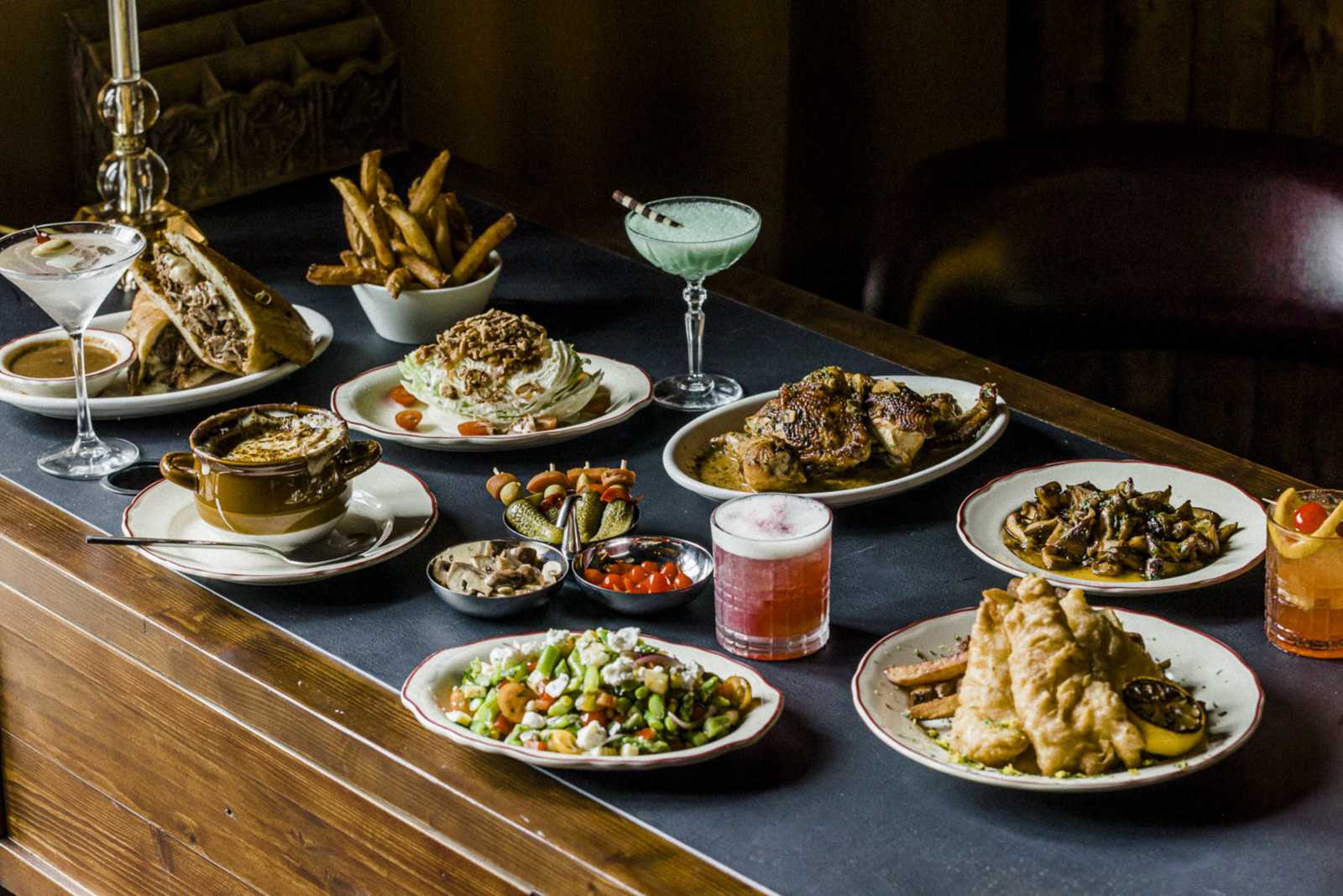 Mercadito dishes and cocktails arranged across the bar