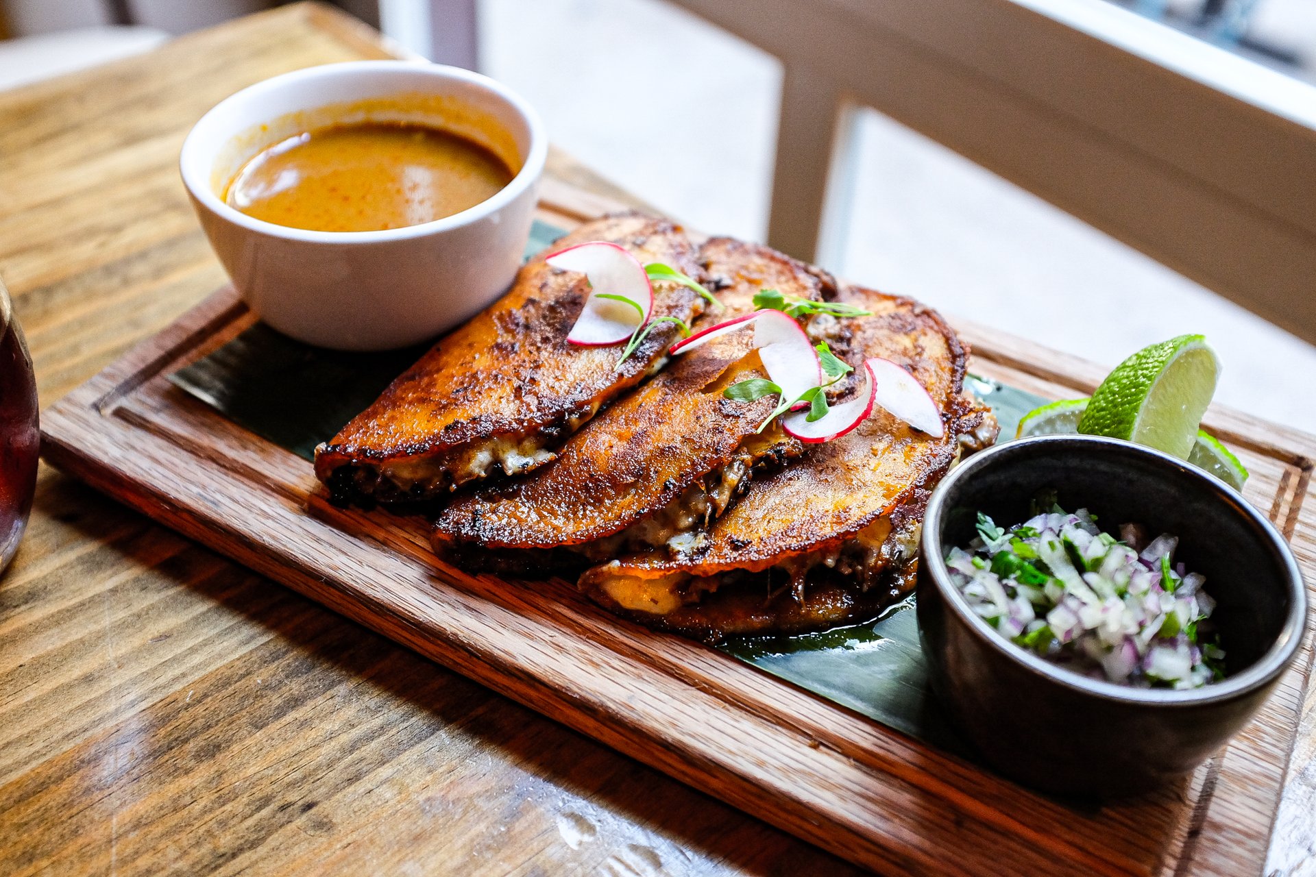 Short Rib Quesabirria tacos with consomme at Mercadito Lincoln Park